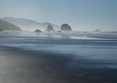 Misty photo of Cannon Beach in Oregon with jutting rocks
