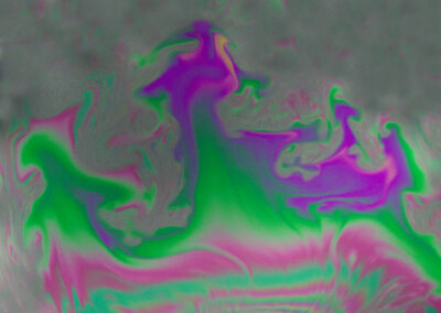 A macro shot of the iridescent surface of a bubble