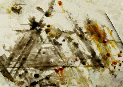 Black streaks with orange highlights in a light yellow mineral matrix