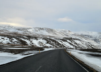 Icelandic highway with snowy hills in background