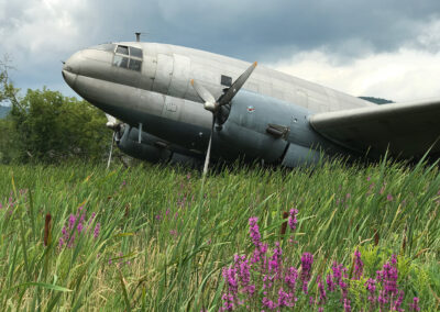 Photo of a 1943 Curtiss C46 transport aircraft in a field in New York