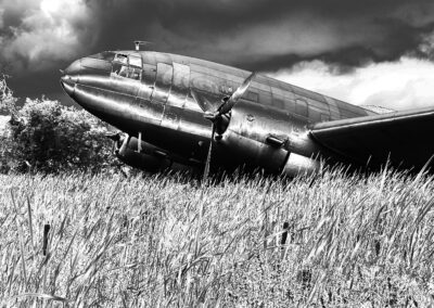Solarized view of a Curtiss C-46 military transport plane in a field