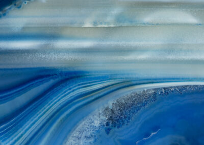 Green and blue layers flow below an aqua skyscape