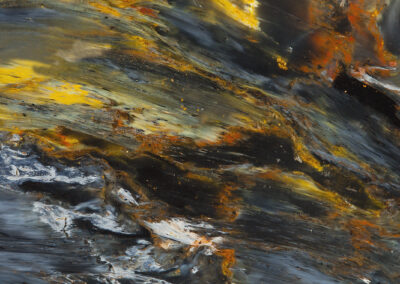 Flowing yellow, white and rust striations in a black background