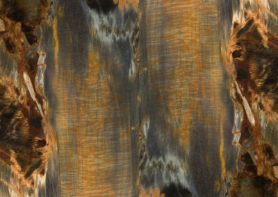 A reflective mineral pattern features cloudy striations in light blue, orange and brown