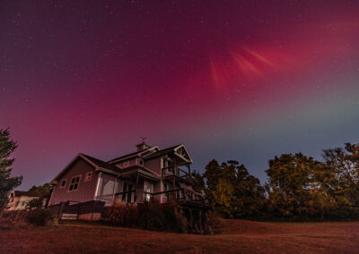 A magenta aurora in the sky over the photographer's Carlin Hill home