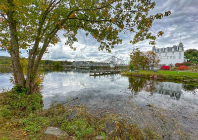 A riverside view of the Swing Bridge and Goodspeed Opera House in East Haddam, Connecticut