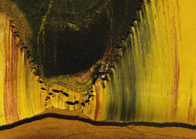 Yellow, green and orange striations with an intruding dark-green canyon