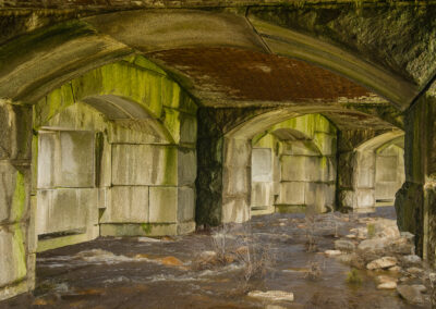 Photo composition of vaulted architecture holding underground river