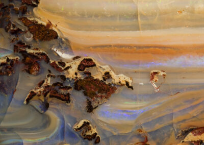 Mineral patterns resemble a figure floating near a mountainous precipice