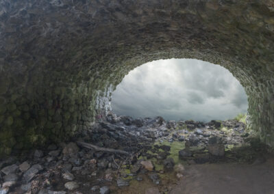 Photo composition of stone tunnel with a clouded opening