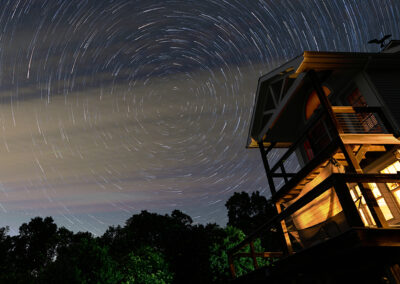 Carlin Hill house at night with time-lapse image of stars