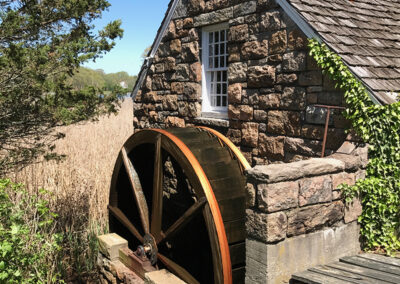 Photo of Setauket Grist Mill in New York, including large water wheel