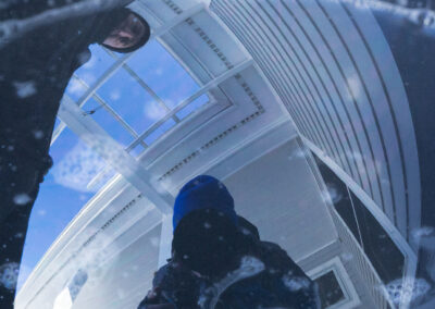 The photographer and bubble artist Casey Carle are reflected in water