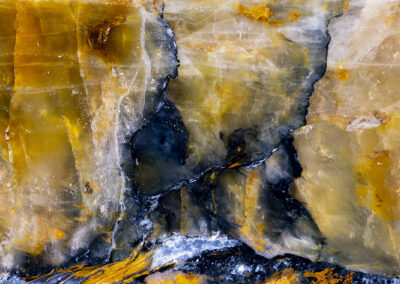Orange and blue mineral formations surmounted by a cracked orange skyscape