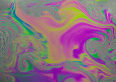 A macro shot of the iridescent surface of a bubble
