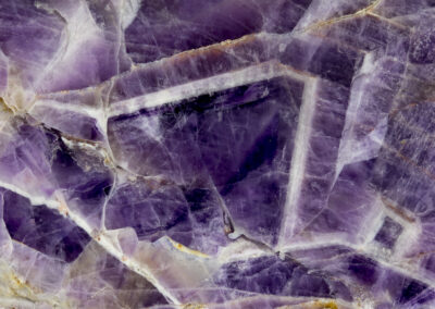 Triangular crystals in a purple amethyst background