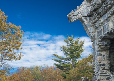 The stone architecture of Gillette Castle with autumn trees