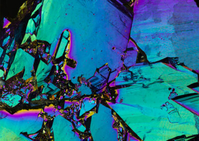 Crystalline structures with iridescent green, blue and prismatic highlights