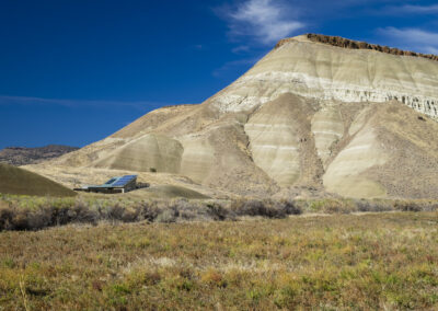 Landscape photo with eroded canyon and small solar array