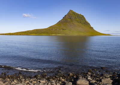 Kirkjufell hill overlooks a rocky coastline