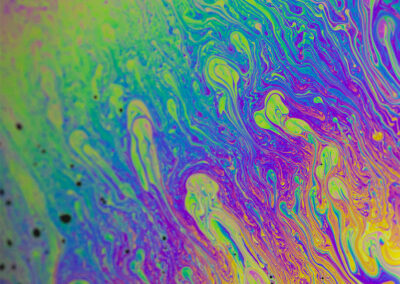 A macro shot of the iridescent surface of a bubble