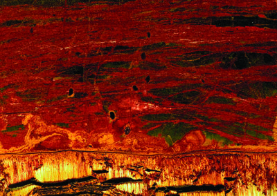 Crystal formations with orange and yellow patterns at the bottom and rust-colord striations at the top