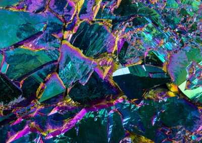 Iridescent crystalline structures with teal, magenta, green and yellow highlights