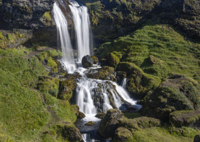 Selvallafoss waterfall and the grassy countryside