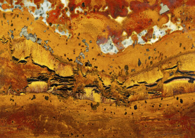 Bright orange and yellow mineral formations suggesting a sunset desert landscape