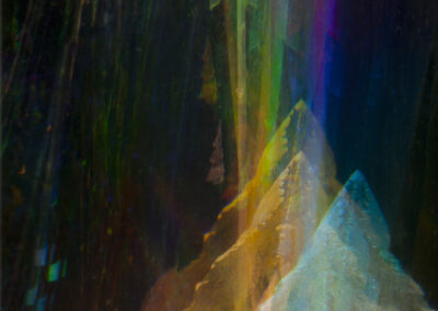 Iridescent stripes run through a peak-like reflected pattern