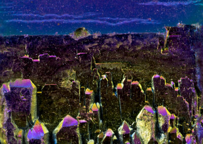 Iridescent crystals grow below a royal blue skyscape