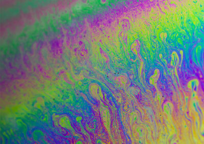 A macro shot of the iridescent surface of a bubble