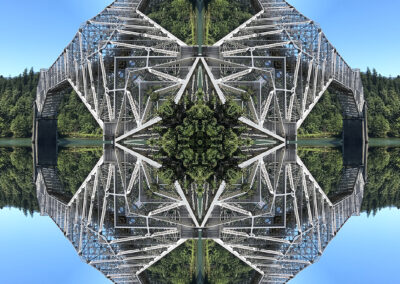 Photo composition of a truss bridge over a forested lake, reflected four ways into a geometric pattern