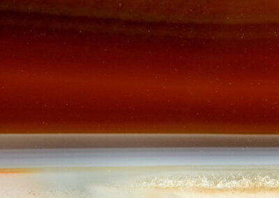 A seascape-like scene with a tan beach and deep red sky