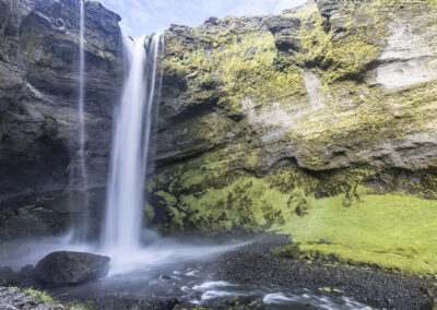 Kvernufoss waterfall amid mossy outcrops