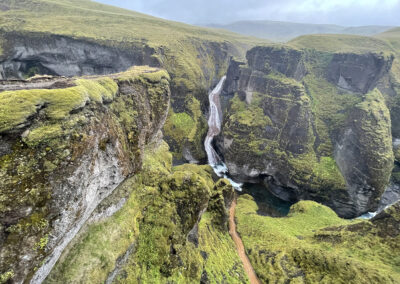 Fjadrargljufur Canyon winds through green hills