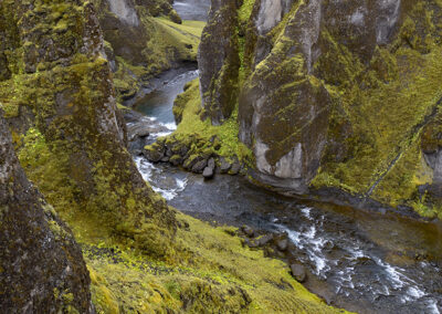 Fjadrargljufur Canyon winds through green hills