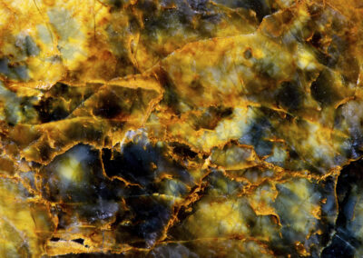 Orange veins in a dark matrix with yellow, green and blue highlights