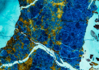 Aqua highlights run through a lapis blue stream with yellow spots