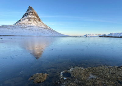 Kirkjufell hill oversees an Icelandic winter sea scene