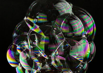 A congeries of iridescent bubbles form patterns and reflections