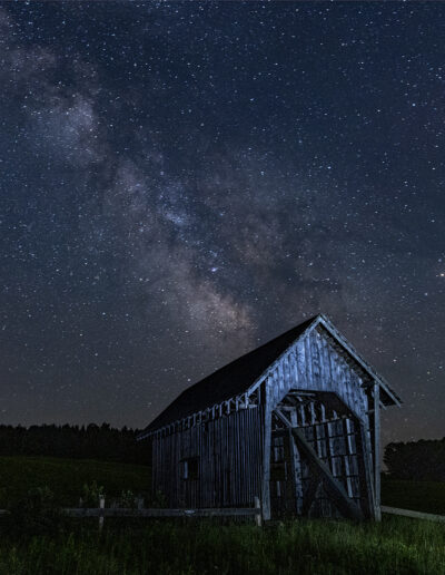 A covered bridge in Vermont under a night sky