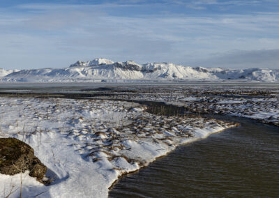 Snowy hills and a watery inlet in Iceland