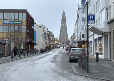 An Icelandic street leads uphill to the Hallgrimskirkja church
