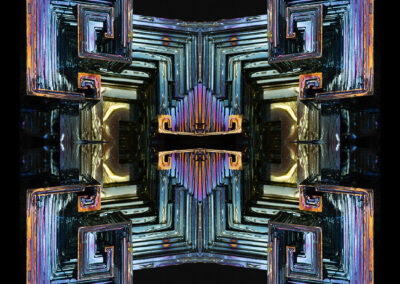 Iridescent cubic crystals reflected to form a symmetrical design