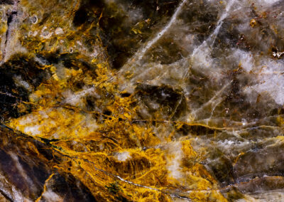 Mineral with orange and white highlights resembling an aerial landscape