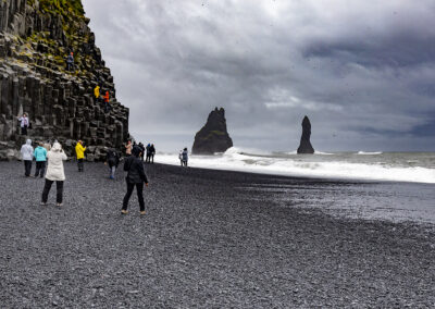 Rocky outcrops, basalt columns and black sand at Reynisfjara, Iceland
