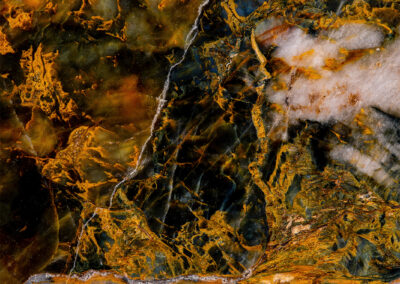 Black venous rock with orange and white highlights resembling lightning and clouds