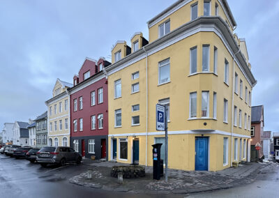 Stately houses painted yellow, red and green on an Icelandic street